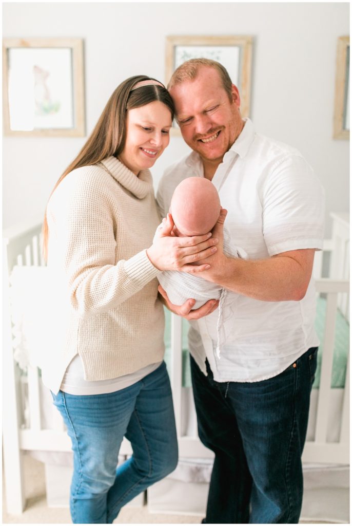 mom and dad holding baby son newborn session