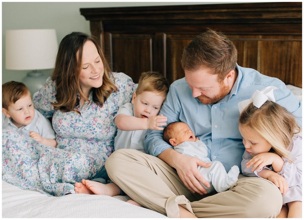 Raleigh Newborn Photography family snuggling on the bed