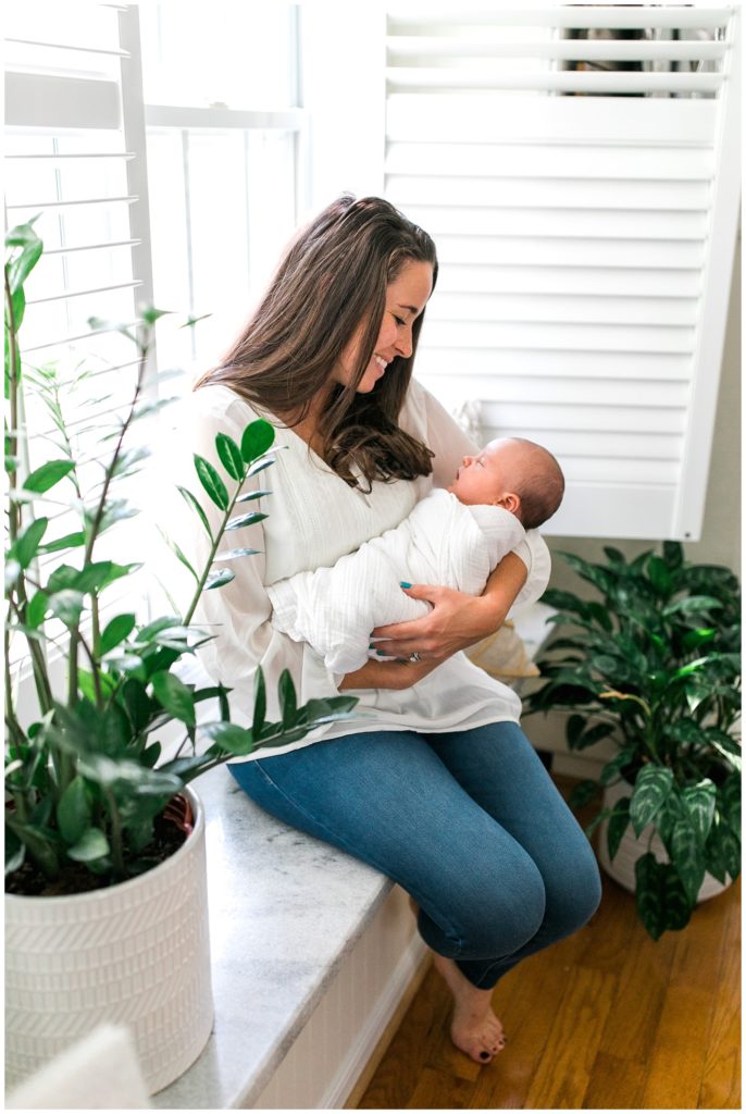 Mom and baby boy in home newborn photographer