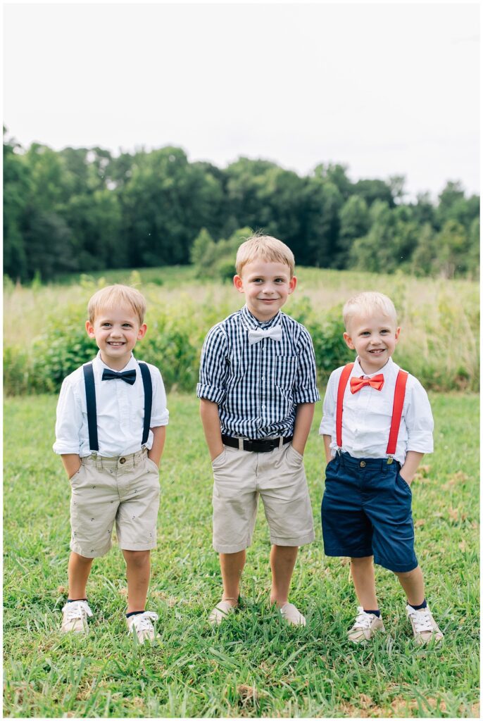 3 brothers in bowties in front of a field