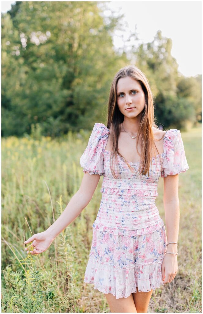 Senior shoot girl in pink dress in a field